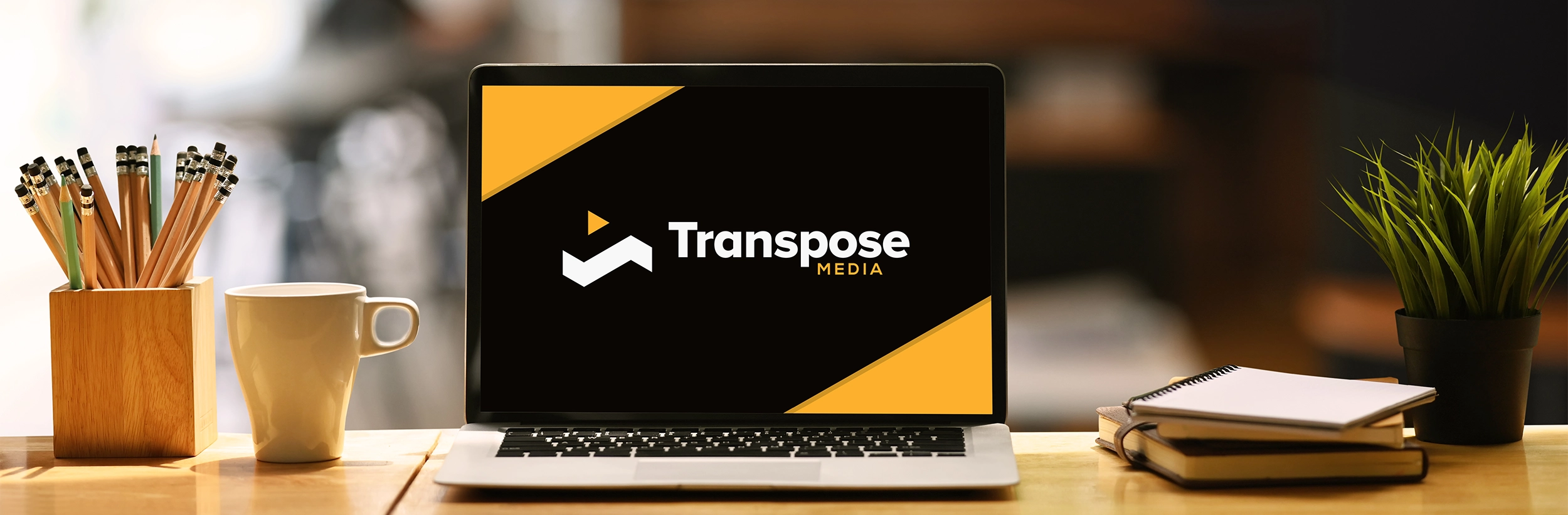 Transpose Media logo on laptop